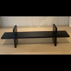 Two black wooden shelves.
